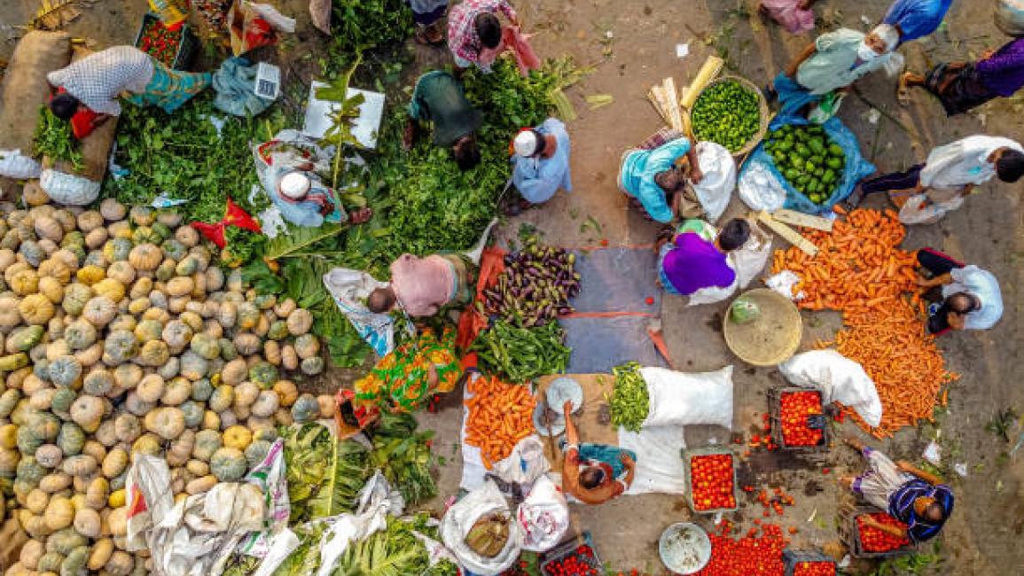 	BARISHAL, BANGLADESH - 2021/04/15: (EDITORS NOTE: Image taken by a drone) People have crowded the Vegetable Market to buy fruits and vegetables ahead of the Muslim Holy month of Ramadan without maintaining social-distancing and some not wearing facial mask amid the Nation-wide lockdown. Bangladesh government has announced a strict lockdown from the 1st Ramadan which started on April 14th and will be continuing for a week. (Photo by Mustasinur Rahman Alvi/Pacific Press/LightRocket via Getty Images)