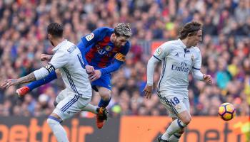 Barcelona's Argentinian forward Lionel Messi (C) falls as he vies with Real Madrid's defender Sergio Ramos (L) and Real Madrid's Croatian midfielder Luka Modric during the Spanish league football match FC Barcelona vs Real Madrid CF at the Camp Nou stadium in Barcelona on December 3, 2016. / AFP / JOSEP LAGO (Photo credit should read JOSEP LAGO/AFP via Getty Images)