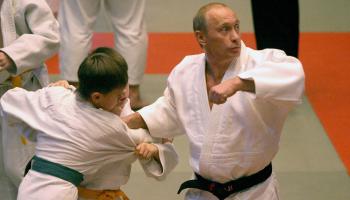 ST.PETERSBURG, RUSSIAN FEDERATION: Russian Presidebt Vladimir Putin (R) makes a throw, demonstrating his judo skills during his visit to a sports school in St. Petersburg, 24 December 2005. AFP PHOTO/ ALEXANDER NIKOLAYEV (Photo credit should read ALEXANDER NIKOLAYEV/AFP via Getty Images)	