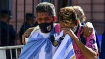 Fans mourn outside the Casa Rosada government house as they wait to pay tribute to Argentinian late football legend Diego Armando Maradona in Buenos Aires, on November 26, 2020. - Argentine football legend Diego Maradona will be buried Thursday on the outskirts of Buenos Aires, a spokesman said. Maradona, who died of a heart attack Wednesday at the age of 60, will be laid to rest in the Jardin de Paz cemetery, where his parents were also buried, Sebastian Sanchi told AFP. (Photo by RONALDO SCHEMIDT / AFP) (